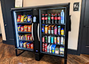 Thumbnail 15 of 29 - A black vending machine with a variety of snacks and drinks inside.