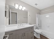 Thumbnail 9 of 25 - A white bathroom with a sink, toilet, and bathtub. at Station Heights, Alpharetta 