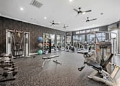 Thumbnail 36 of 48 - Gym with a variety of equipment including weights and cardio machines at The Ambrose, Houston, TX, Texas, 77040