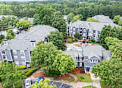 Thumbnail 2 of 51 - A bird's eye view of a residential area with houses and trees.