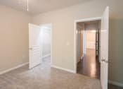Thumbnail 14 of 51 - A room with two open doors and carpeted flooring.