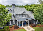 Thumbnail 1 of 51 - A house with a blue door and white trim.