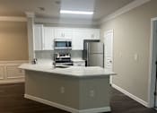Thumbnail 3 of 39 - a kitchen with white cabinets and a white counter top at The Berkeley Apartments, Georgia, 30096
