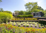 Thumbnail 16 of 16 - a garden with flowers and bushes in front of a sign that says the edge at The Edge of Germantown, Tennessee