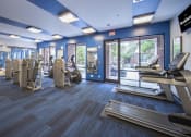 Thumbnail 20 of 33 - a gym with cardio equipment and a glass door at The Haven, Atlanta Georgia