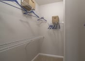 Thumbnail 14 of 33 - a walk in closet with two hanging racks and a box on the wall at The Haven, Atlanta, GA