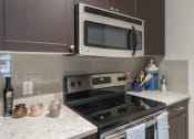 Thumbnail 4 of 33 - a kitchen with a stove and a microwave in it at The Haven, Atlanta, 30329