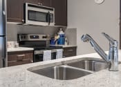 Thumbnail 3 of 33 - a kitchen with stainless steel appliances and granite counter tops at The Haven, Atlanta Georgia
