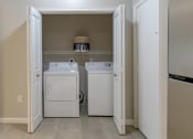 Thumbnail 13 of 33 - a washer and dryer in a laundry room with doors open at The Haven, Atlanta, 30329