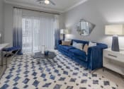 Thumbnail 6 of 33 - a living room with a blue couch and a blue and white rug at The Haven, Georgia, 30329