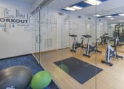 Thumbnail 23 of 33 - a gym with exercise equipment and glass walls at The Haven, Atlanta, GA