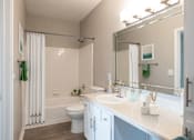 Thumbnail 11 of 37 - a bathroom with a shower toilet and sink at The Moorings, League City