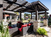 Thumbnail 18 of 33 - Seating Area at Pool  located at Retreat at Steeplechase in Houston, TX 77065