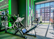 Thumbnail 18 of 43 - Gym with leg machine at Chelsea Apartments, St Louis