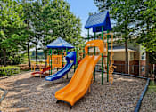 Thumbnail 32 of 33 - A playground with a blue and orange slide.