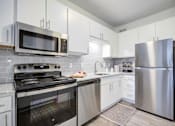 Thumbnail 2 of 23 - Kitchen with Black oven at The Waters at Chenal Apartments, Little Rock
