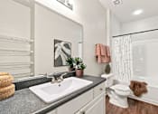 Thumbnail 15 of 34 - A bathroom with a white toilet and a white sink.