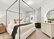 Thumbnail 7 of 34 - A bedroom with a four poster bed, a nightstand, and a dresser.