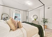 Thumbnail 8 of 34 - A bedroom with a large bed and a mirror on the wall.