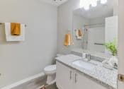 Thumbnail 10 of 27 - a bathroom with a sink and a toilet and a mirror at Twenty35 at Timothy Woods, Georgia