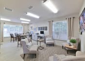 Thumbnail 19 of 27 - a living room with couches and chairs and a dining room with a table at Twenty35 at Timothy Woods, Athens