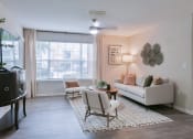 Thumbnail 5 of 27 - a living room with a couch and a chair and a table at Twenty35 at Timothy Woods, Athens, 30606
