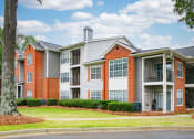 Thumbnail 25 of 27 - an apartment building with red brick and white siding at Twenty35 at Timothy Woods, Athens, 30606