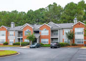 Thumbnail 27 of 27 - an apartment building with cars parked in a parking lot at Twenty35 at Timothy Woods, Athens, Georgia