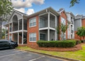 Thumbnail 26 of 27 - an apartment building with a car parked in front of it at Twenty35 at Timothy Woods, Athens