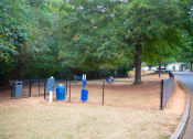 Thumbnail 24 of 27 - a park with a chain link fence and blue trash cans at Twenty35 at Timothy Woods, Athens, Georgia