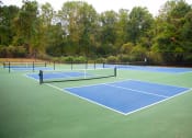 Thumbnail 23 of 27 - a tennis court on a green and blue court at Twenty35 at Timothy Woods, Georgia, 30606