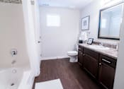 Thumbnail 7 of 22 - a bathroom with a shower toilet and sink and a mirror