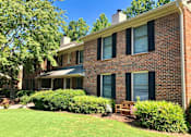 Thumbnail 19 of 33 - A house with a green lawn and a tree in front. at Villas on Briarcliff, Atlanta, GA