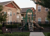 Thumbnail 22 of 23 - Children have a place to run and play at Villas too! Slides, Climbing Equipment and Bike Parking at Villas at Carrington Square Apartments, Overland Park, KS 66221