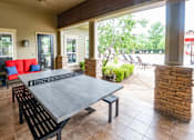 Thumbnail 21 of 26 - A patio with a table and chairs is shown.