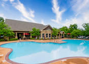 Thumbnail 17 of 26 - A large swimming pool in front of a house.