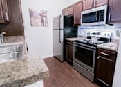 Thumbnail 3 of 22 - a kitchen with stainless steel appliances and granite counter tops
