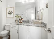Thumbnail 3 of 10 - Bathroom with white cabinetry and quartz countertop