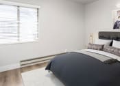 Thumbnail 4 of 10 - Bedroom with hardwood flooring, white walls, and a window