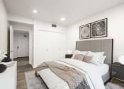 Thumbnail 11 of 34 - Bedroom with hardwood flooring, white walls, and a closet