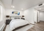 Thumbnail 10 of 34 - Bedroom with hardwood flooring and white walls