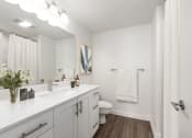Thumbnail 13 of 34 - Bathroom with white cabinetry and white countertop