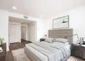 Thumbnail 9 of 34 - Bedroom with hardwood flooring, white walls, and closets