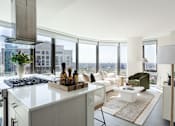 Thumbnail 2 of 36 - A modern kitchen with a view of the city.