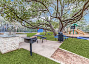 Thumbnail 22 of 30 - A park with a playground, picnic table, and a mailbox.