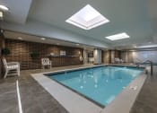 Thumbnail 11 of 16 - Indoor swimming pool with seating area