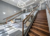 Thumbnail 13 of 16 - Entrance into lobby with a close up of a staircase next to a seating area