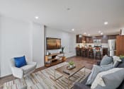 Thumbnail 3 of 16 - Furnished living space and dining area with plank style flooring, open concept, stainless steel appliances, dark cabinets