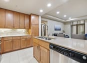 Thumbnail 5 of 25 - a kitchen with wooden cabinets and a white counter top