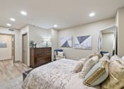 Thumbnail 8 of 25 - a bedroom with a large bed and a dresser